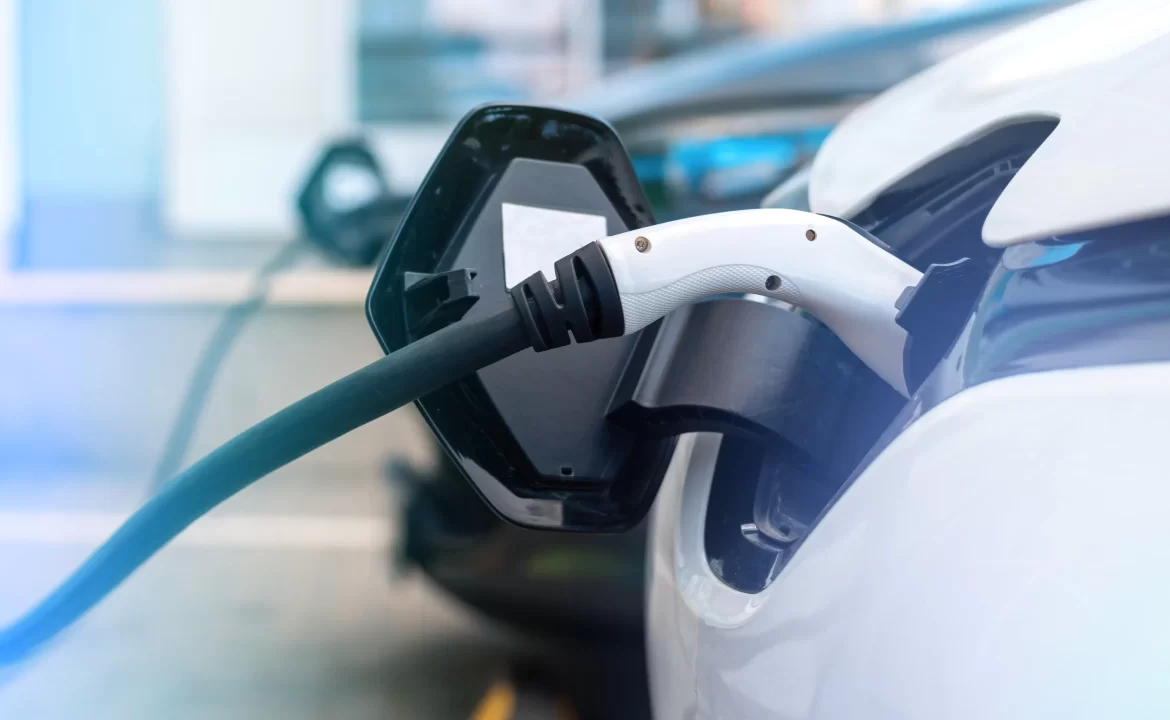 Two electric cars plugged into charging stations